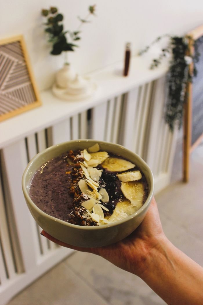 Delicious homemade berry pudding with bananas and almonds in an indoor setting.