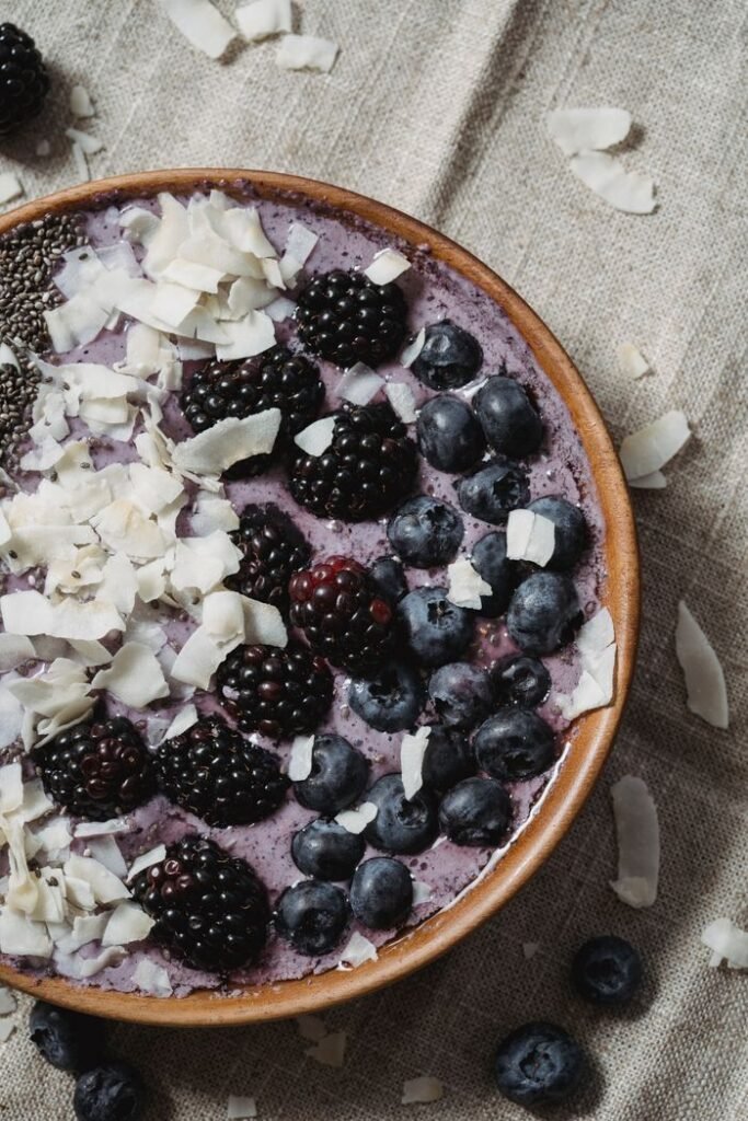 Delicious smoothie bowl topped with blackberries, blueberries, chia seeds, and coconut flakes.