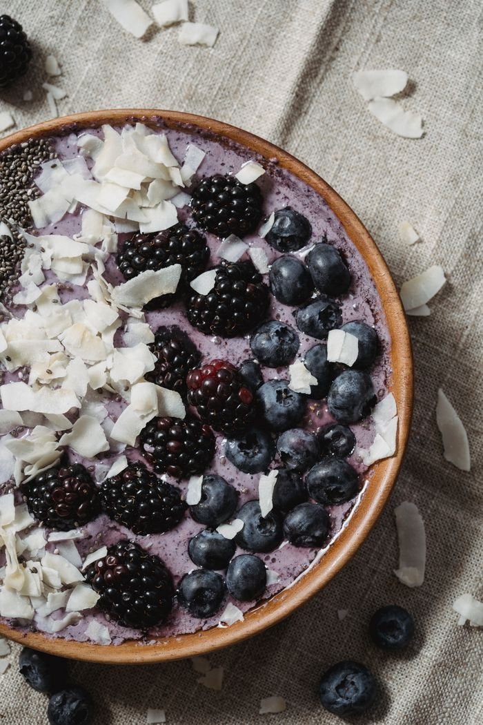 Delicious smoothie bowl topped with blackberries, blueberries, chia seeds, and coconut flakes.